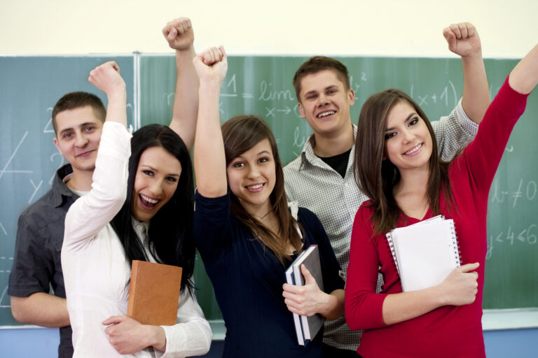 3 girls and 2 boys lift their hand up with confidence